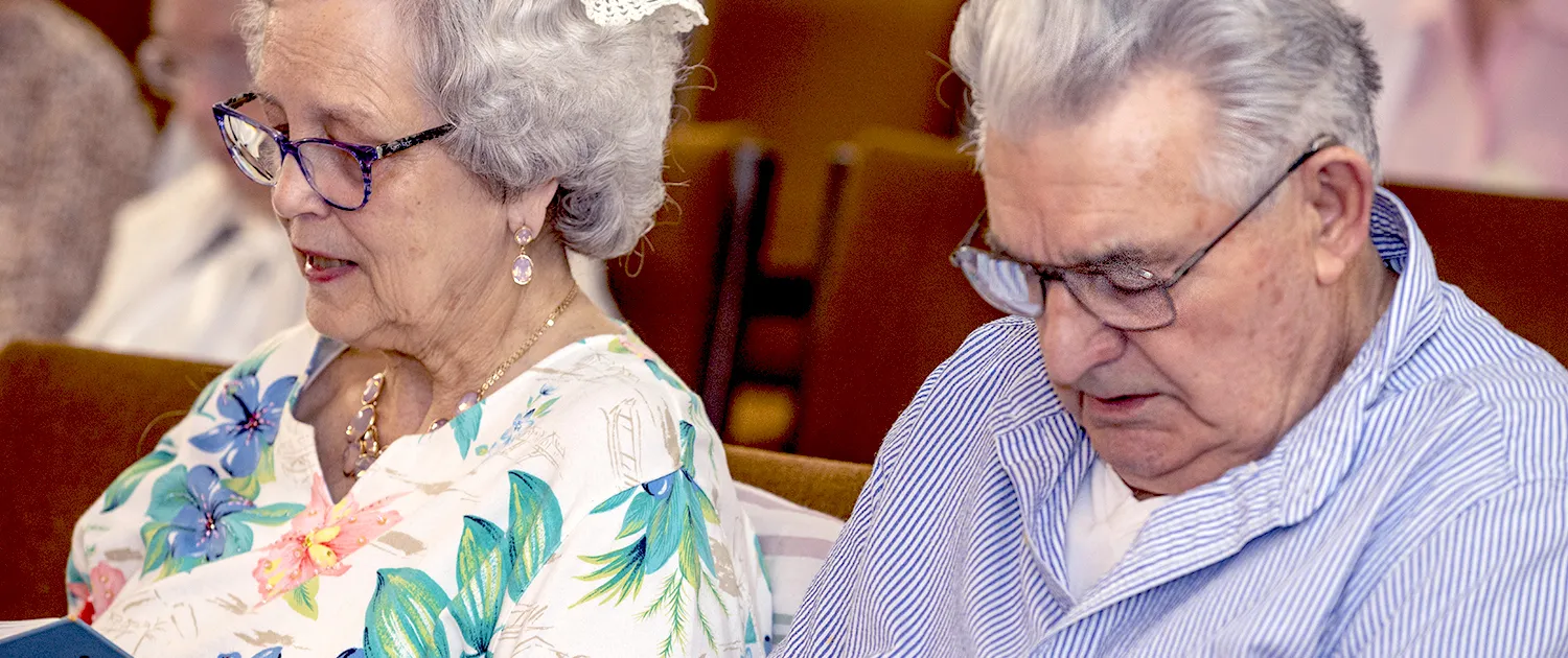 A resident singing together with neighbors during an assembly gathering