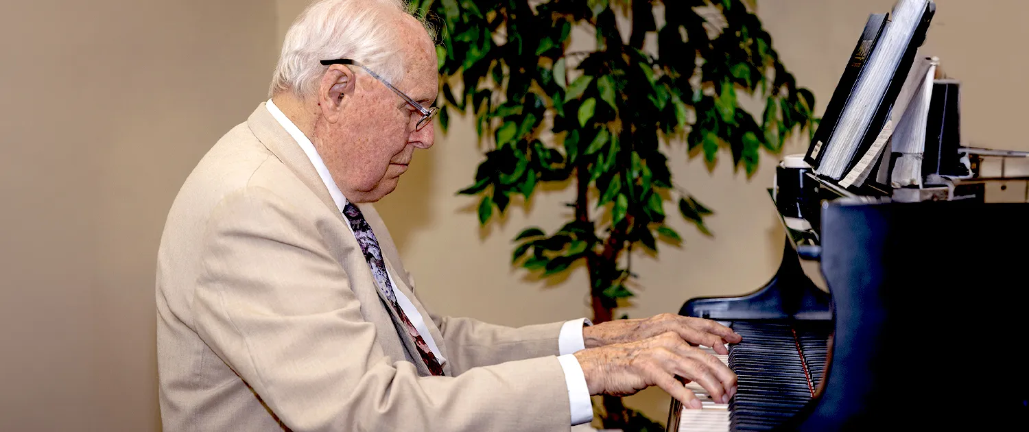 A resident sharing music at the piano
