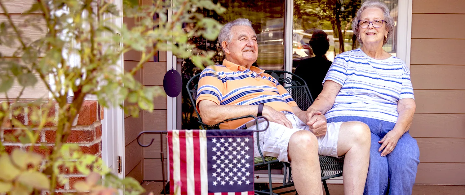 A resident relaxing inside a Village apartment